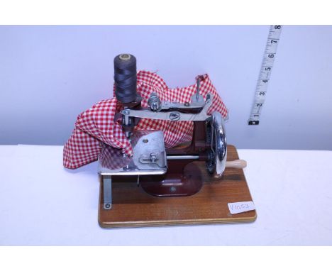 A vintage child's toy sewing machine 