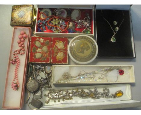 A mixed lot of mainly costume jewellery to include a cameo brooch, coral necklace, silver bracelet, B.C jade necklace and mat