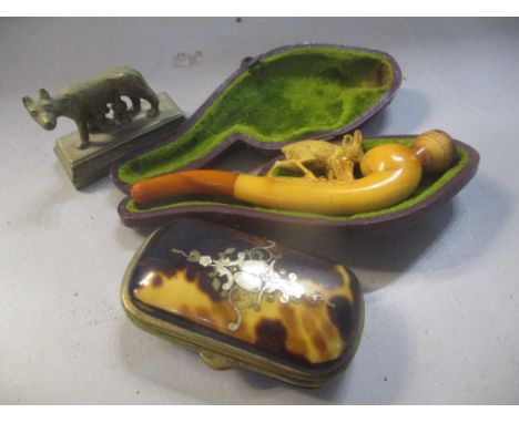 A late 19th century Meerschaum carved pipe in a case together with a tortoise shell box and a miniature Italian wolf ornament