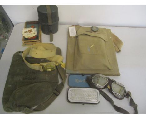 A mixed lot to include a British Army white parade belt a US field protective mask M9A1 bag, leather goggles, maps, canvas fi