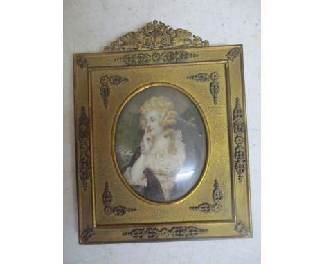 A miniature portrait paining of a young woman wearing red jewelled ear pendants, mounted in a 19th century gilt brass frame, 