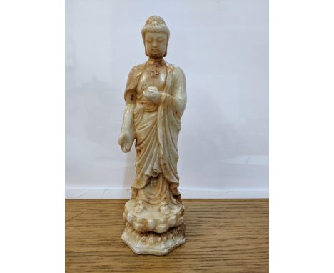 A Chinese off white and rust jade coloured statue of a man holding a bowl on a lotus base 