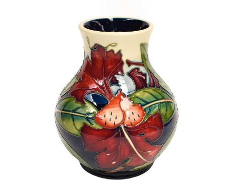 A modern Moorcroft pottery baluster shaped vase, decorated in the Simian design