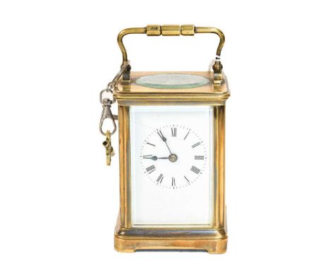 A brass striking carriage clock, circa 1900Condition report: The brass case is discolored. The dial with hairline crack. Orig