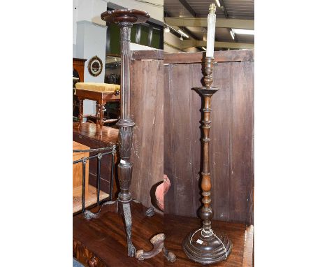 A late 19th century carved mahogany torchere, 140cm high, a circa 1930's oak standard lamp, and a Victorian pedestal music st