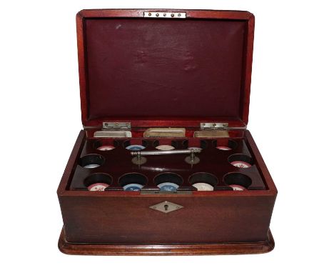 An early 20th century mahogany gaming box fitted with a gambling chip caddy, and compartments for three decks of cards