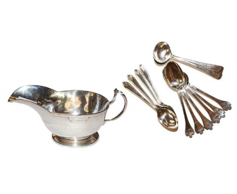 A quantity of silver items comprising; a silver milk jug, set of silver tea spoons, makers mark JBC &amp; S and a set of four