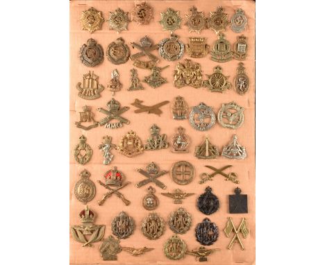 A collection of military cap badges, including: Royal Engineers, Royal Naval Division, Royal Army Services Corps, Army Ordnan
