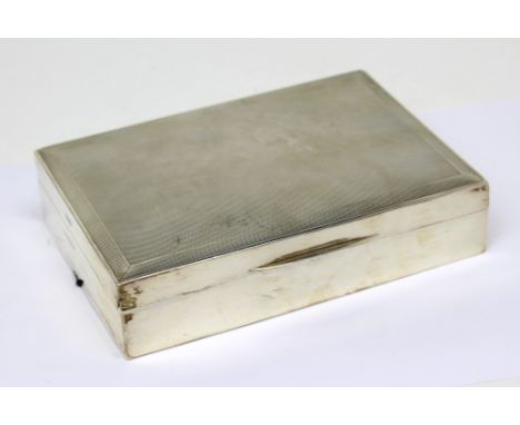 A George VI hallmarked silver engine-turned cigarette box with wood liner, Birmingham 1941, length 17cm.