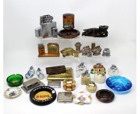 A collection of tobacciana to include plated cigarette case, tobacco jars, cigarette lighters, table lighters and a large met