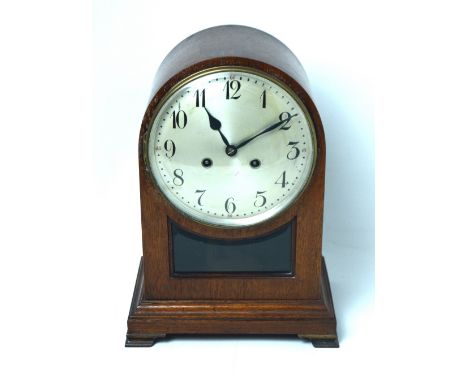 An early 20th century mahogany-cased eight-day mantel clock, silvered dial set with Arabic numerals.