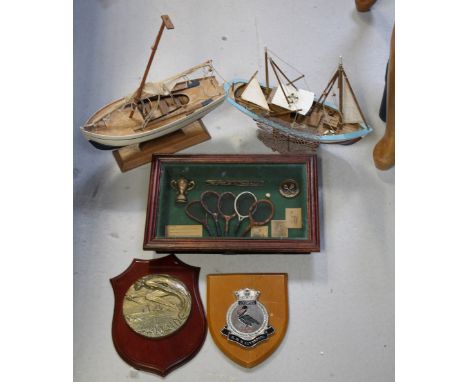 A small collectors' lot to include two small model boats, a metal plaque mounted on wooden shield for 'HMS Liverpool', a bras