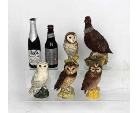 A set of four Royal Doulton Scotch whisky owl decanters modelled by John Tongue; 'Short-Eared Owl', 'Tawny Owl', 'Snowy Owl' 