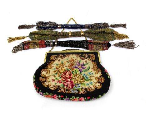 Three Victorian woven purses decorated with silver and gold beads and thread and an Edwardian tapestry evening bag in fancy g