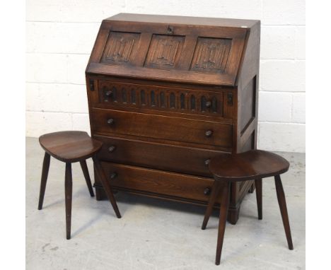 A Priory oak bureau with fall-front above four drawers, width 76cm and two Ercol-style stools (3).