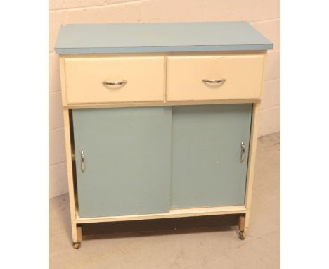 A vintage kitchen cabinet, two drawers over two sliding doors, in white and blue painted finish. CONDITION REPORT Small chips