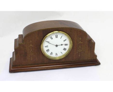 A French mantel clock in Art Deco style walnut case, the white enamel dial set with Roman numerals, inlaid decoration to eith