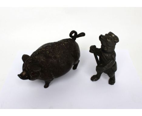 An early 20th century cast iron novelty counter bell modelled as a pig, length 17cm, also a spelter table lighter modelled as