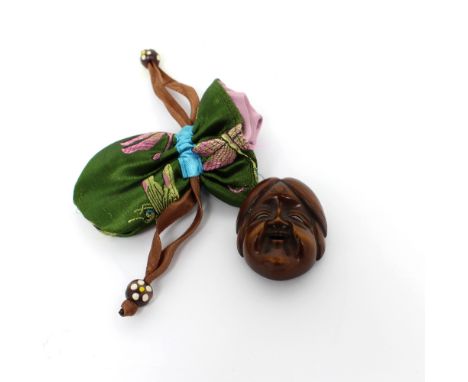 A Japanese carved wooden netsuke modelled as a Noh mask, signed 4 x 3.5cm.