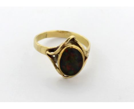 A 9ct gold dress ring set with an oval opal in scrolling mount, size O, approx 2.9g.