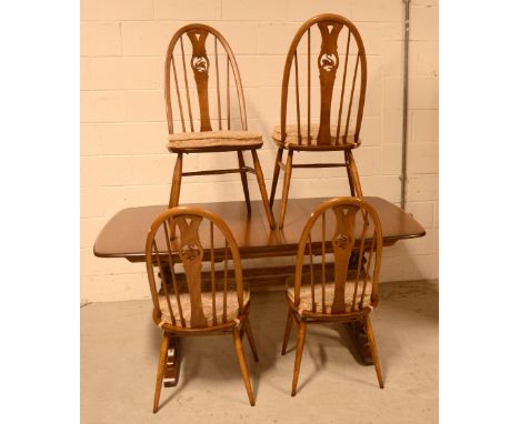 An Ercol extending dining table and four chairs (5).