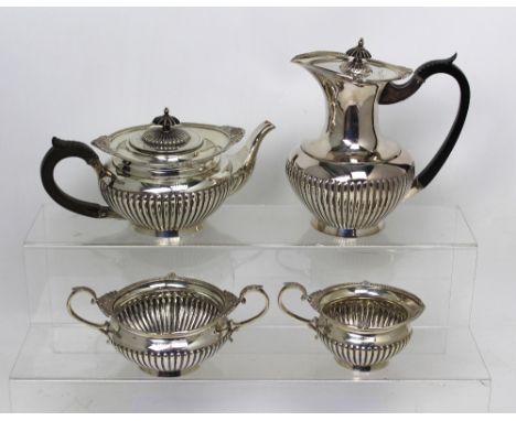 A George VI hallmarked silver tea service comprising a tea pot, milk jug, sugar bowl, Walker & Hall, Sheffield 1946, approx c