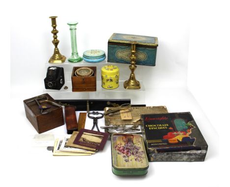 A collectors' lot to include various vintage tins, a pair of brass candlesticks, a Box Brownie, vintage drawbridge game, a pa