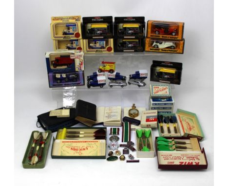 A collection of boxed Lledo and Days Gone toy cars, boxed darts, playing cards etc.