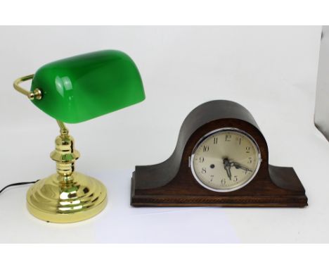 A brass desk lamp with emerald green glass shade and a mid-20th century oak-cased Napoleon hat mantel clock, the gilded dial 