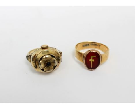 A 15ct yellow gold gentlemen's signet ring, the central oval carnelian with gilt letter F, size S, approx 5.2g and a gold-pla