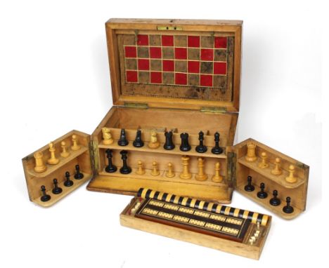 A mid-20th century games compendium, hinged front enclosing a fruitwood and ebonised chess set, draughts, bone dominoes, crib