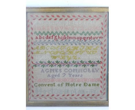 A mid 19th century polychrome needlework sampler, by Agnes Connolly, aged 7, dated 1866. H.36cm W.32cm