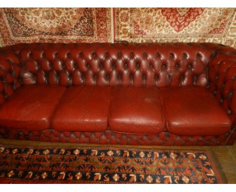 A Chesterfield style red leather four seater button back sofa.