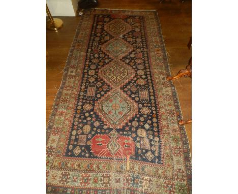 A Persian blue ground Bakhtiar runner, having four pole medallion to centre on a stylised flower ground, multi-bordered and f