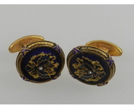 A pair of Russian silver gilt and guilloche enamelled cufflinks, centred with an Imperial eagle set with a small diamond, wit