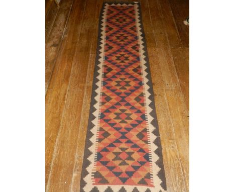 A Persian Kelim runner, having geometric patter, fringed. L.205cm W.50cm 