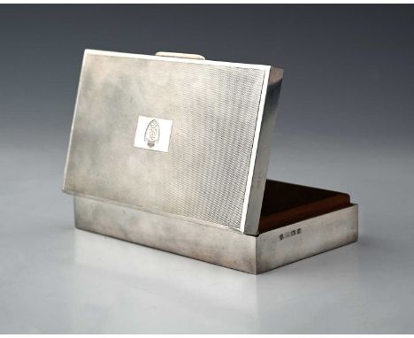 An Elizabeth II silver cigarette box with engine turning on top with a wood-lined interior, inscribed 'I.D.R.C. 16th March 19