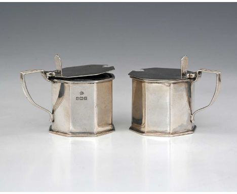 A pair of George V silver octagonal mustard pots, with blue glass liners, William Hutton &amp; Sons, Birmingham, 1914, height