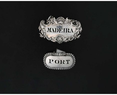 A nineteenth-century English silver die-stamped wine label or bottle ticket, decorated with foliate scrolls and shells, pierc
