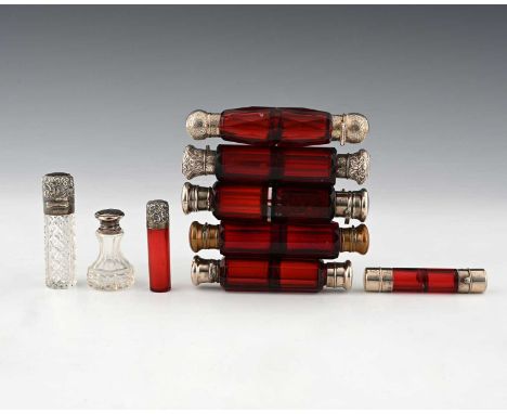 A group of nine scent bottles or perfume bottles, to include ruby glass double-ended examples, length (of larger) 13cm approx