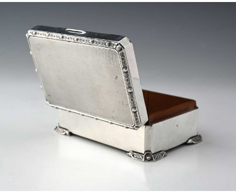 An Elizabeth II silver cigarette box, of rectangular form with canted corners, the body with engine-turning, and with Lindisf