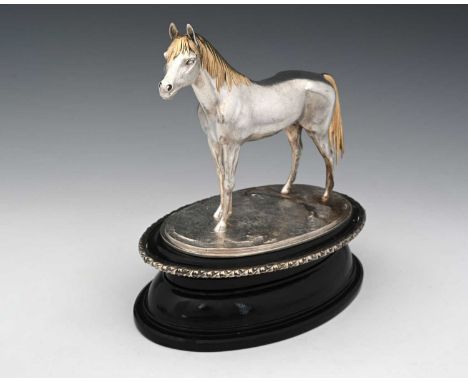 An Elizabeth II parcel-gilt silver horse model, cast and realistically modelled as a stallion, the mane and tail highlighted 