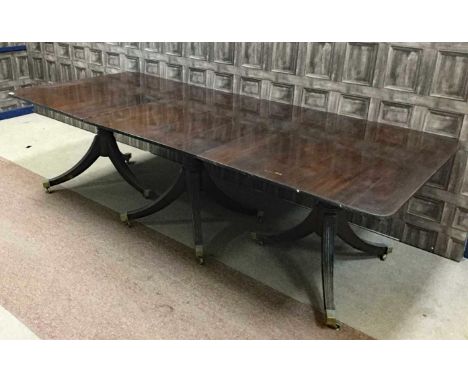 MAHOGANY TRIPLE PILLAR EXTENDING DINING TABLE, of Regency design, the top with reeded edge, supported on turned, ringed taper