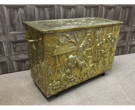 LATE 19TH CENTURY BRASS COAL BOX, with hinged cover, the front panel embossed with a genre scene, twin handles, raised on fou