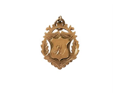 VICTORIAN NINE CARAT GOLD MEDALLION, the obverse with engraved decoration and central shield shaped plaque with inscribed ini