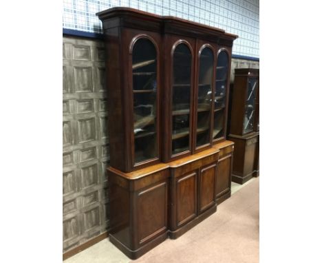VICTORIAN MAHOGANY LIBRARY BOOKCASE, the lofty moulded cornice with adjustable shelving below enclosed by four arch glazed do