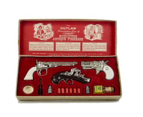 A BCM “The Outlaw Presentation Case Of Miniature Antique Firearms”, comprising Flintlock handgun, Derringer style pistol, Col