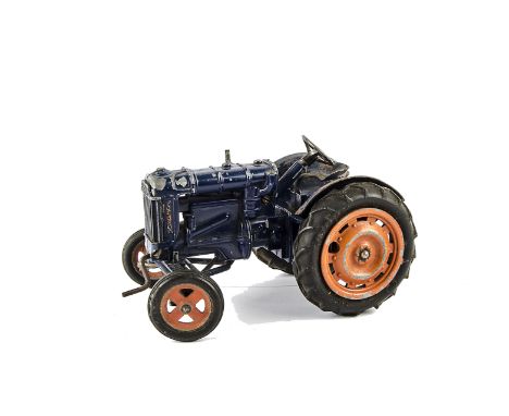 A Chad Valley clockwork Fordson Major Tractor, in blue with red hubs, F, clockwork requires attention, exhaust pipe broken, g