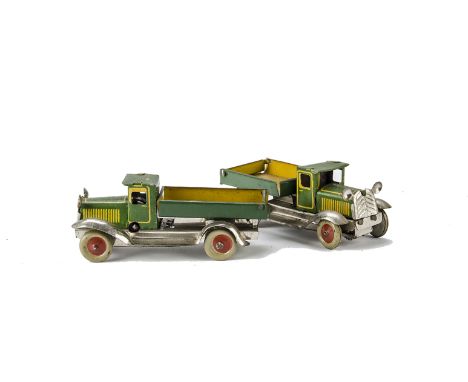 A pair of pre-war Japanese clockwork Tin Tipper Trucks, with green cabs and backs with yellow base and chrome grills and whee