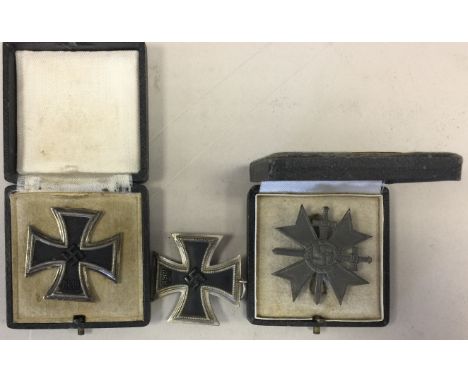 THIRD REICH. Two boxed and one unboxed third reich medals issued in 1939 to include: an iron and black enamel cross with swas